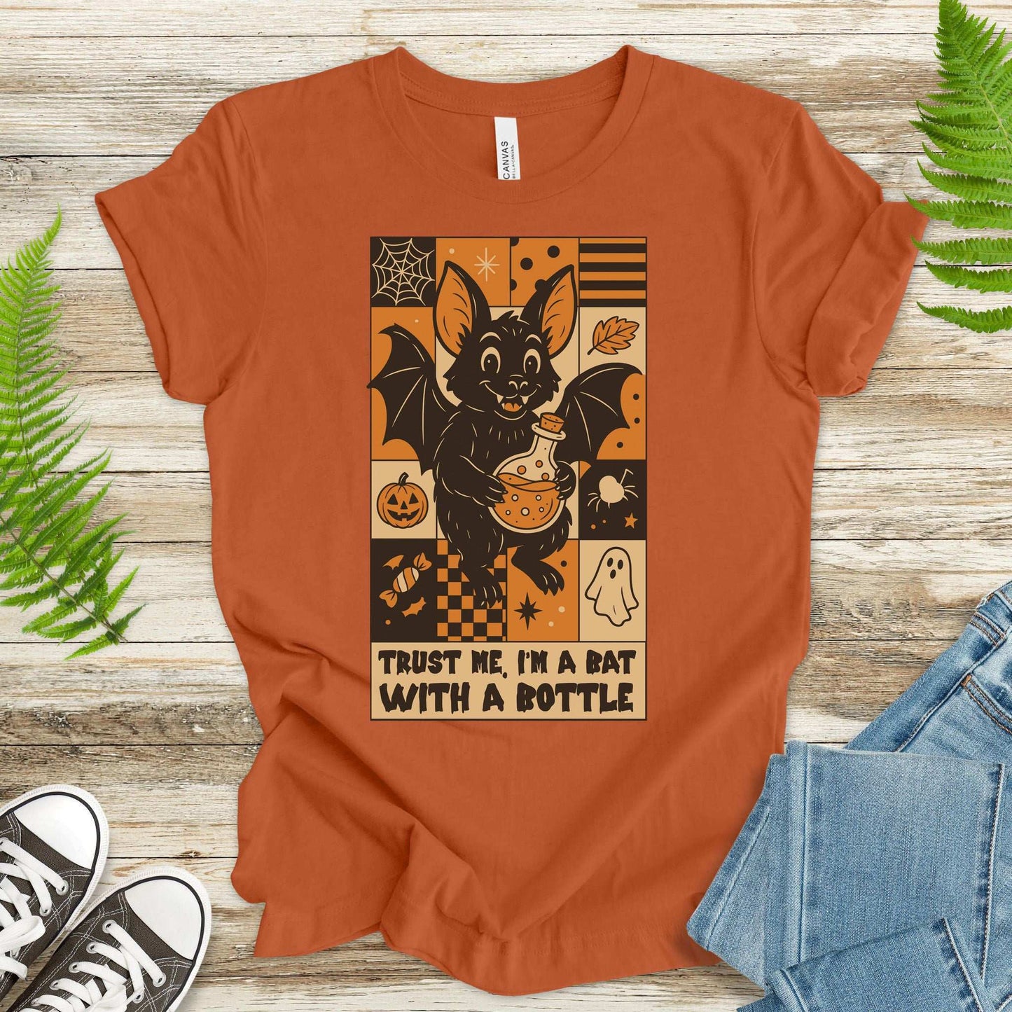 Retro Halloween T-shirt featuring a bat with a potion saying "Trust Me, I'm a Bat With a Bottle" for spooky fun.