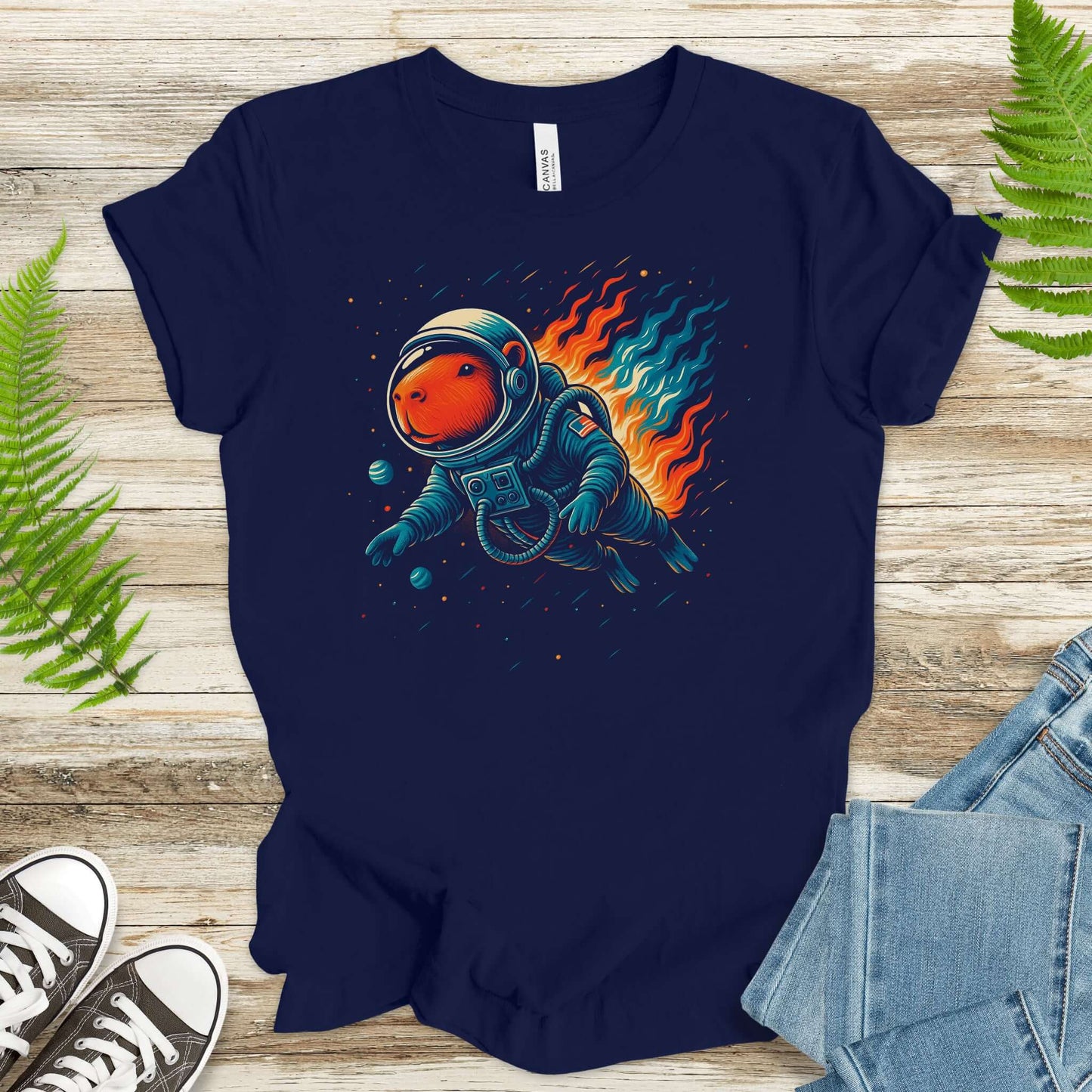 Capybara astronaut t-shirt for fantasy lovers, featuring a relaxed capybara floating in space with cosmic flames.