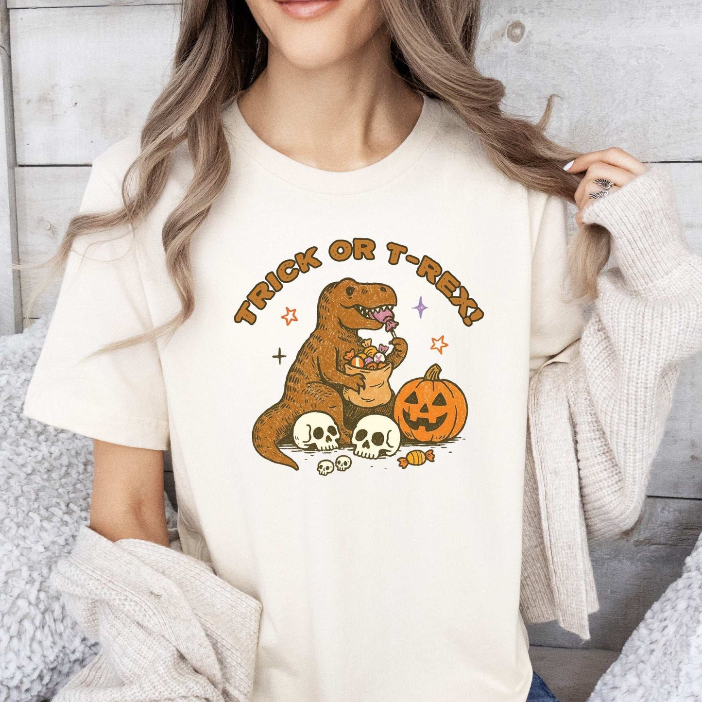 T-Rex Halloween T-Shirt featuring a dino with candy, pumpkins, and skulls for Trick or Treat Dino Candy Chaos.
