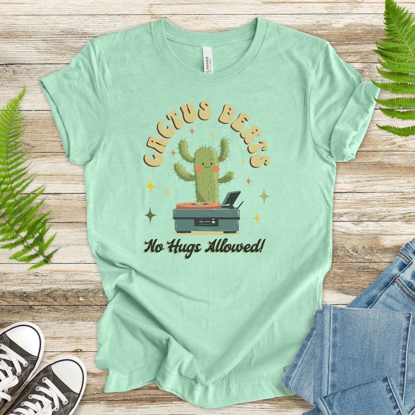 Funny Retro DJ Cactus T-Shirt in soft cotton, featuring a cactus DJ and the phrase 'No Hugs Allowed', perfect for music lovers.