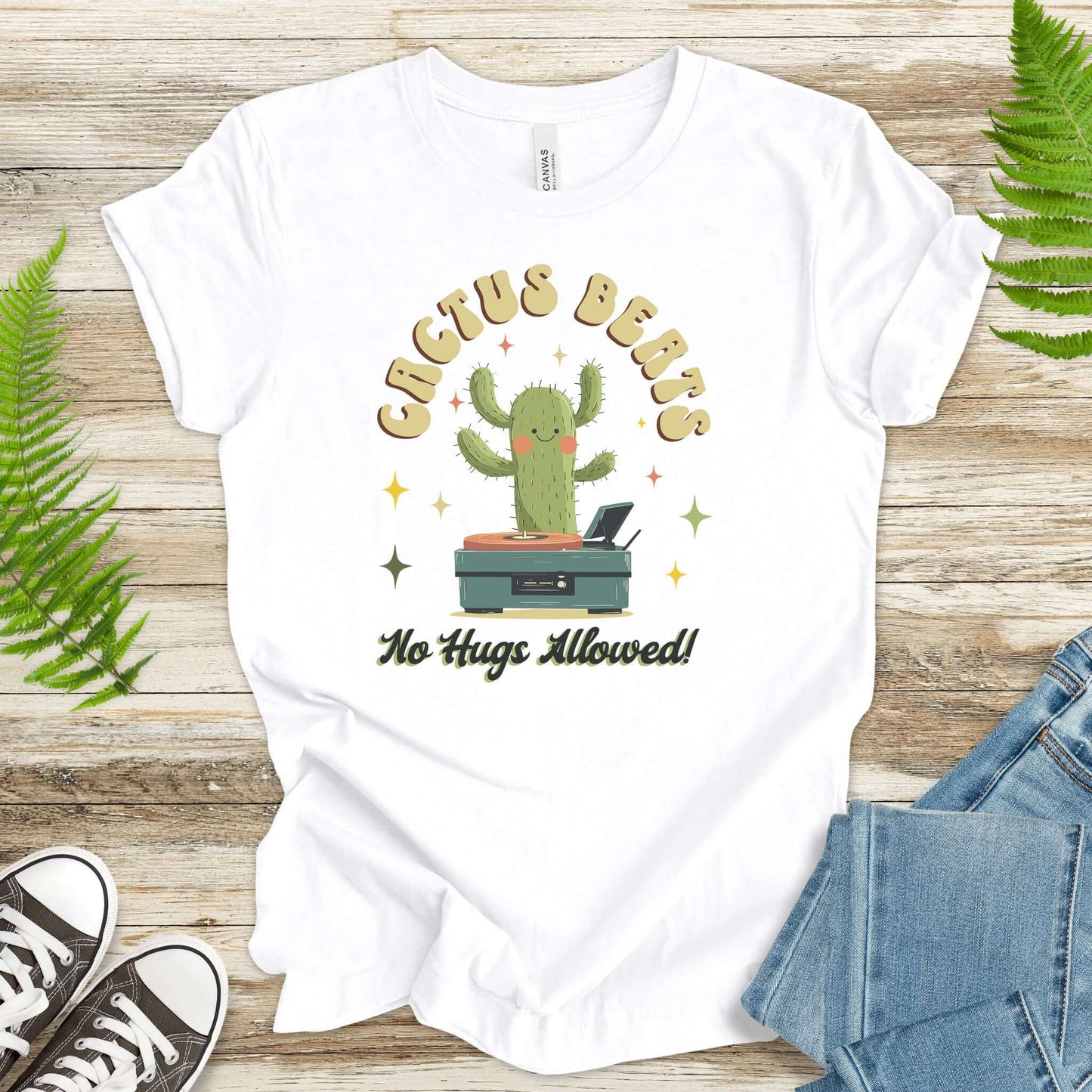 Funny retro cactus DJ T-shirt in soft cotton, features the text 'Cactus Beats No Hugs Allowed!', perfect for music lovers.