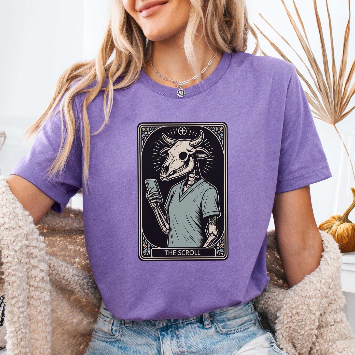 The Scroll Skeleton T-shirt featuring a bull skull design and tarot card elements, perfect for modern goth culture.