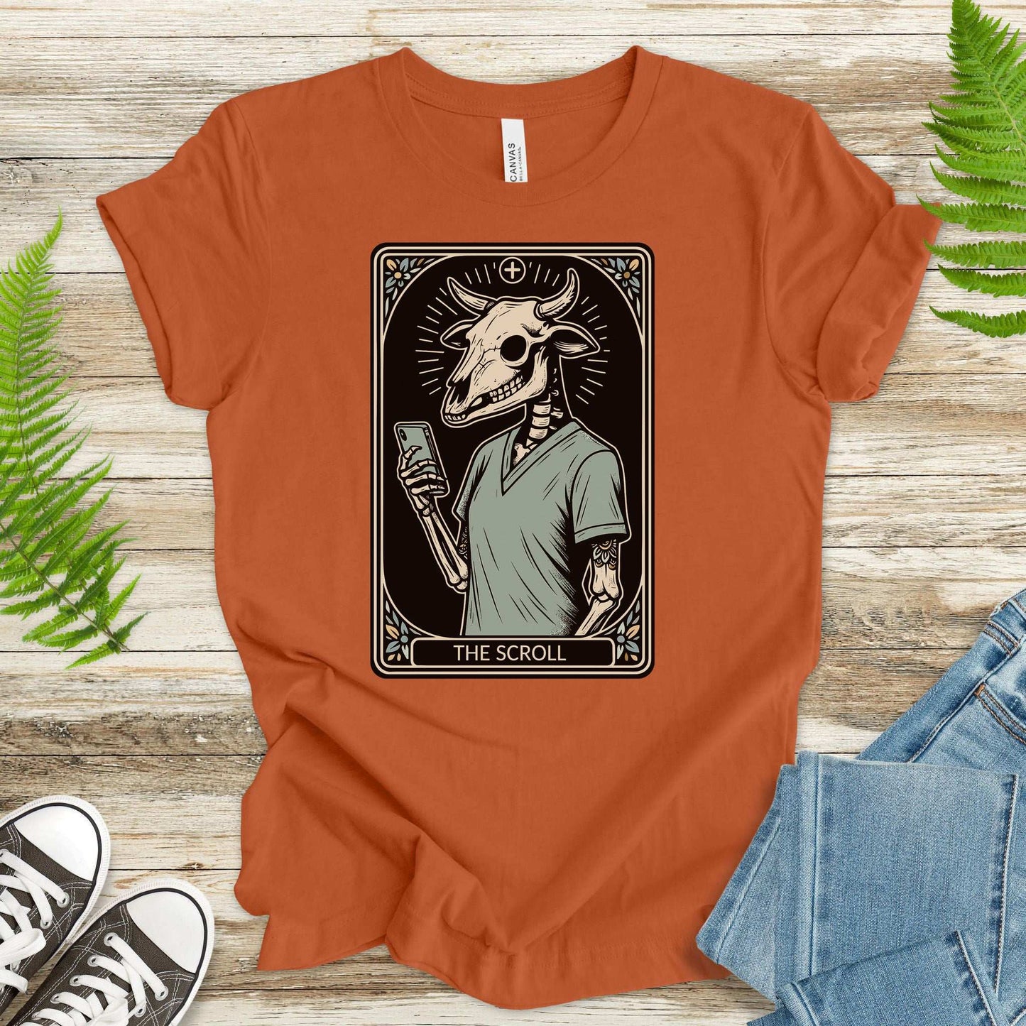 The Scroll Skeleton T-shirt featuring a bull skull tarot card design, perfect for phone addicts and goth culture lovers.