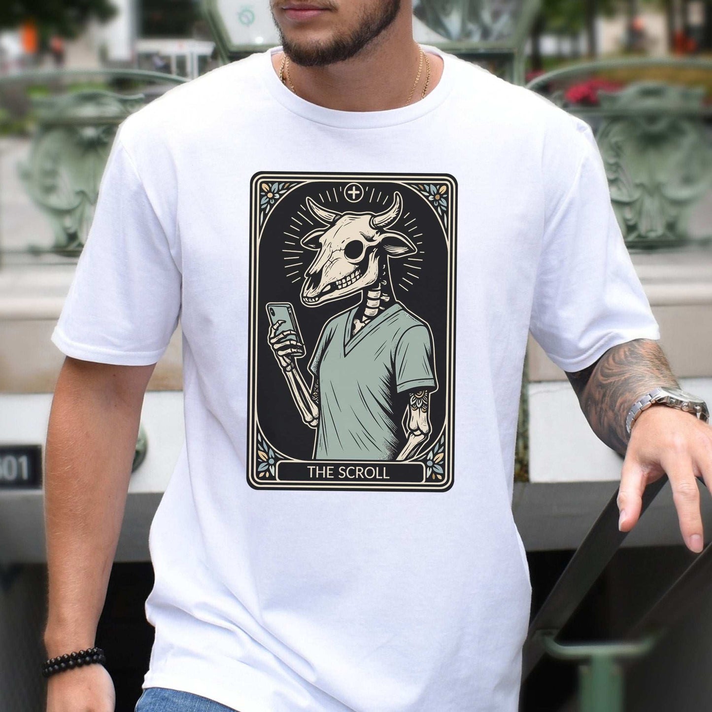 The Scroll Skeleton T-shirt featuring a bull skull tarot card design for tech addicts and goth culture.