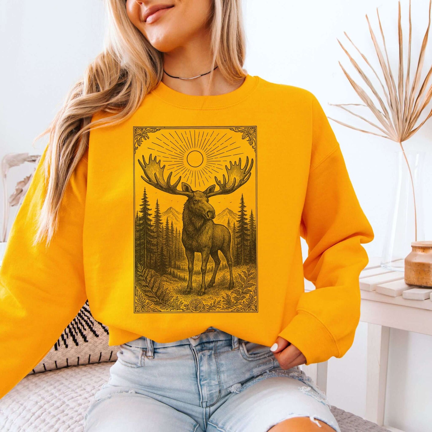 Mystic Moose Crewneck sweatshirt featuring a majestic bull moose under sun with forest backdrop, retro wildlife art.