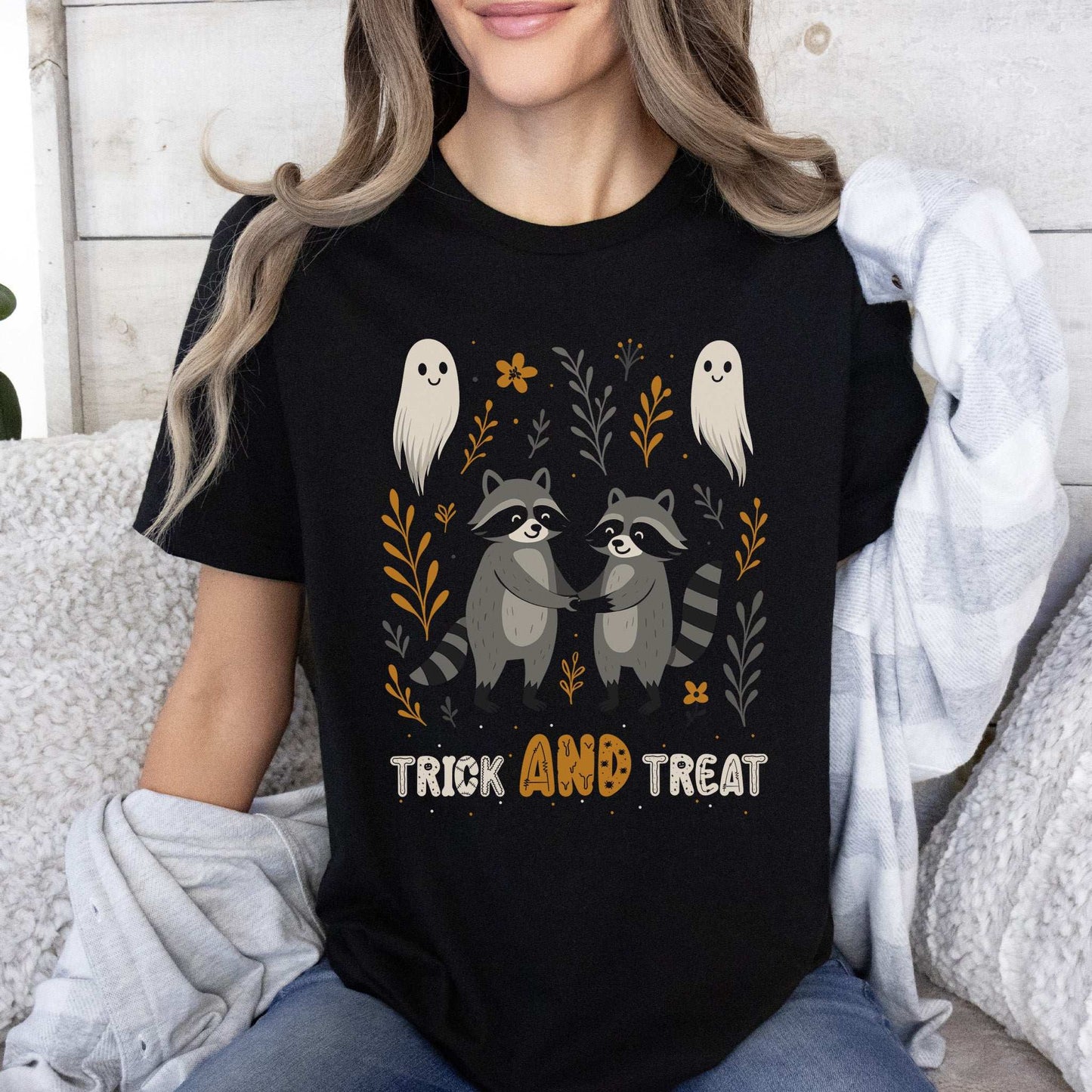 Trick AND Treat Raccoon Halloween T-shirt featuring cute raccoons and ghosts, perfect for spooky season.