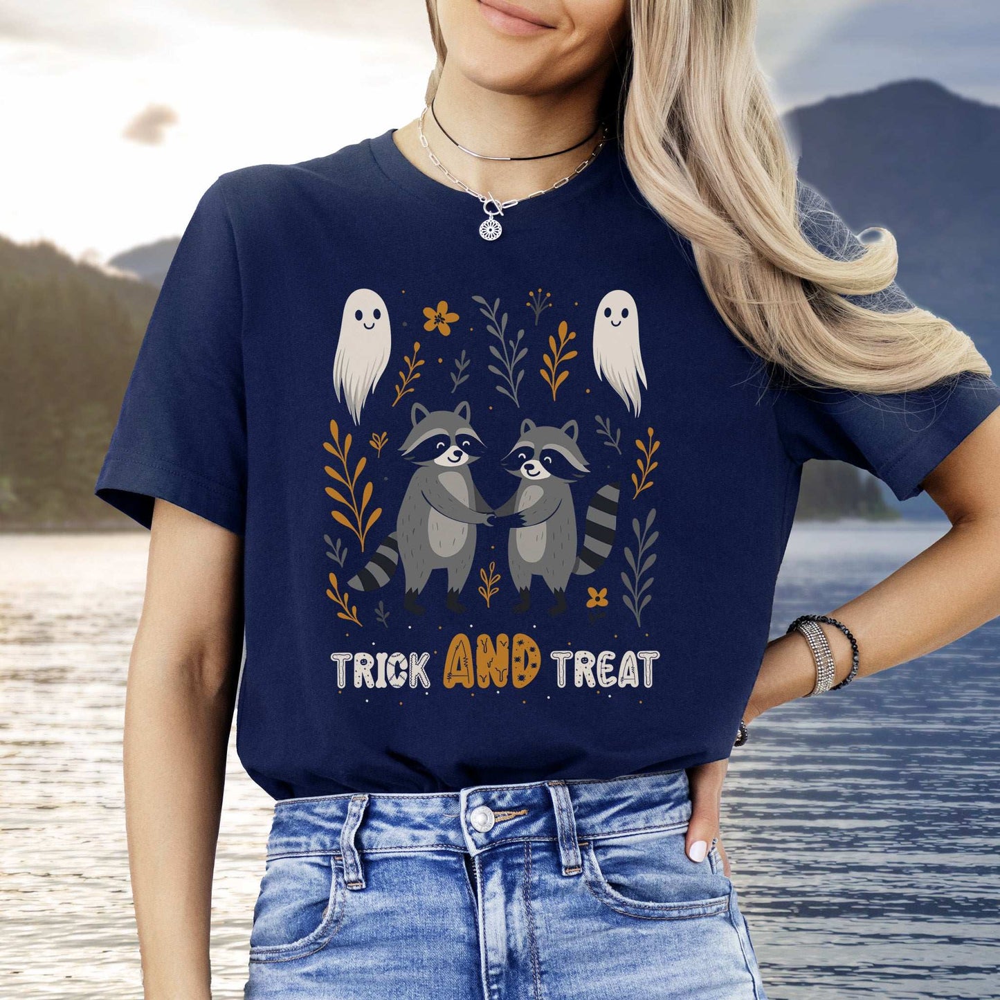 Trick AND Treat raccoon Halloween T-shirt featuring cute ghosts and woodland designs, perfect for autumn mischief.