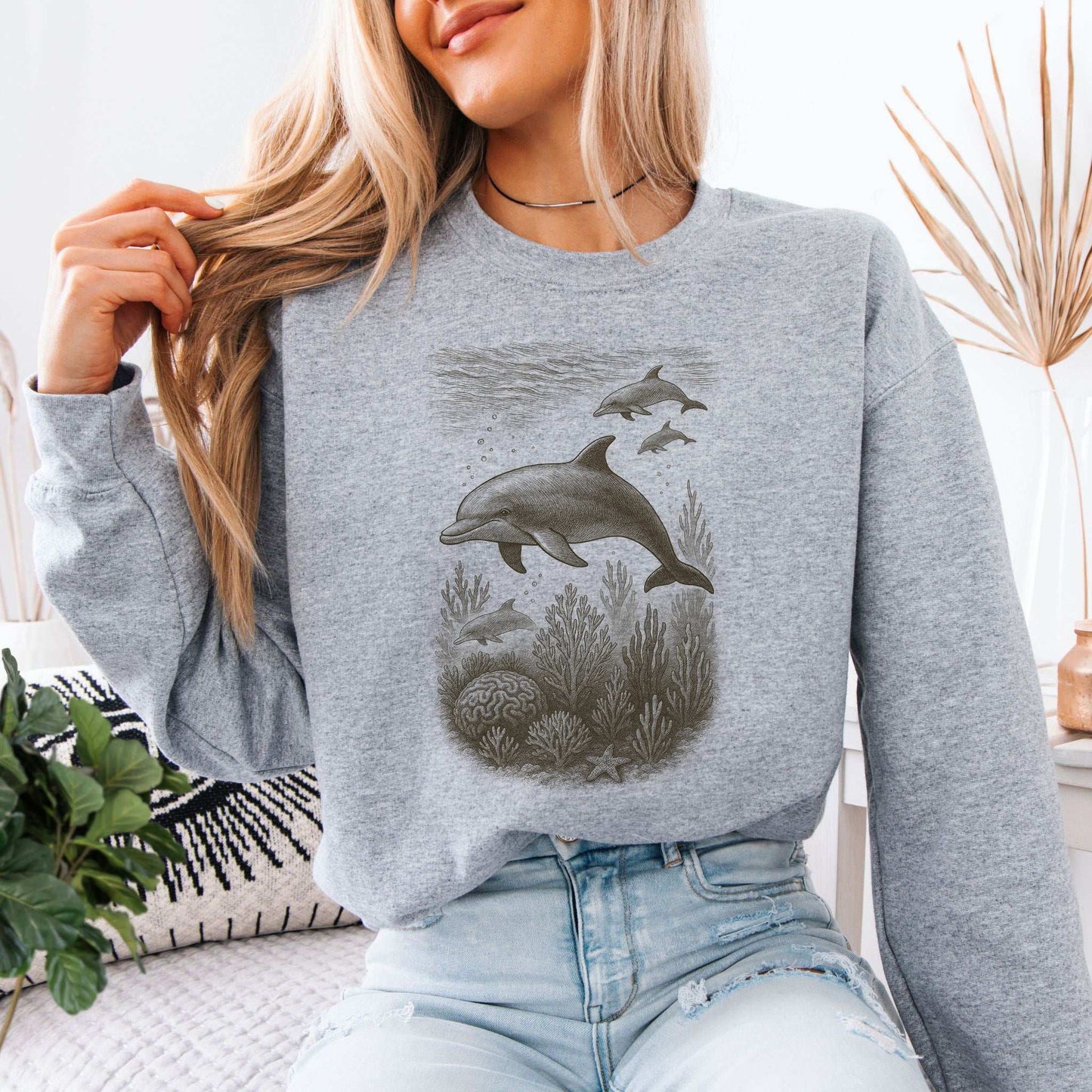Dolphins and coral reef sketch on a cozy gray sweatshirt, showcasing ocean spirit animal vibes.