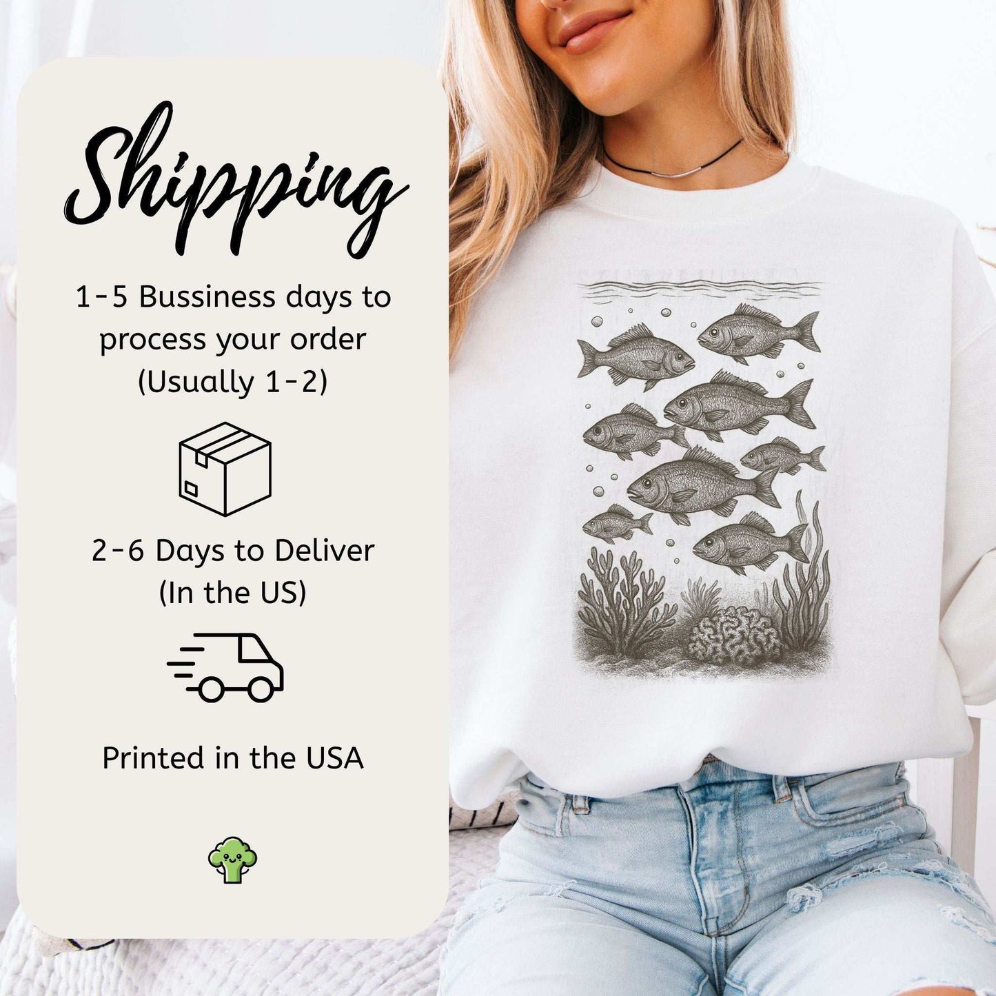 Woman wearing Fish Sweatshirt featuring school of fish over corals, promoting ocean life appreciation.