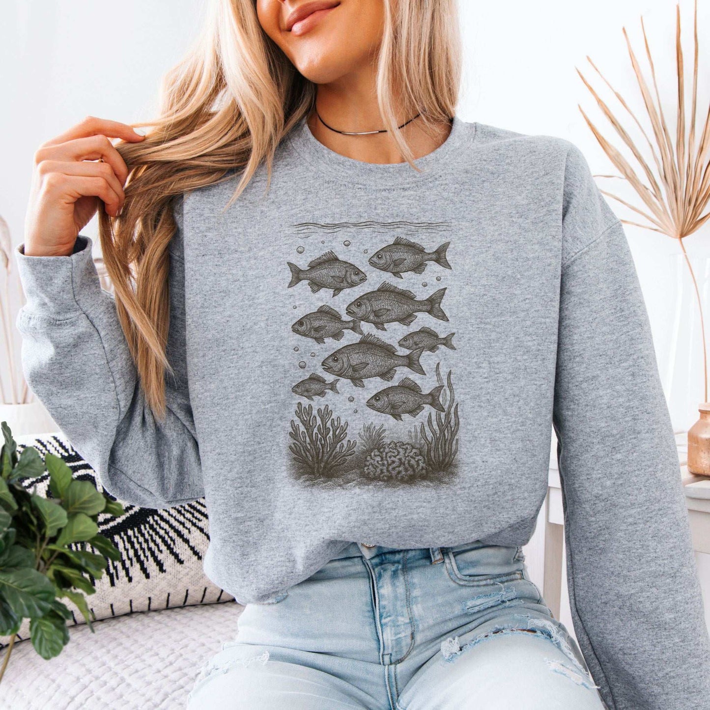 Fish sweatshirt featuring a hand-drawn school of fish and corals, ideal for ocean life lovers.