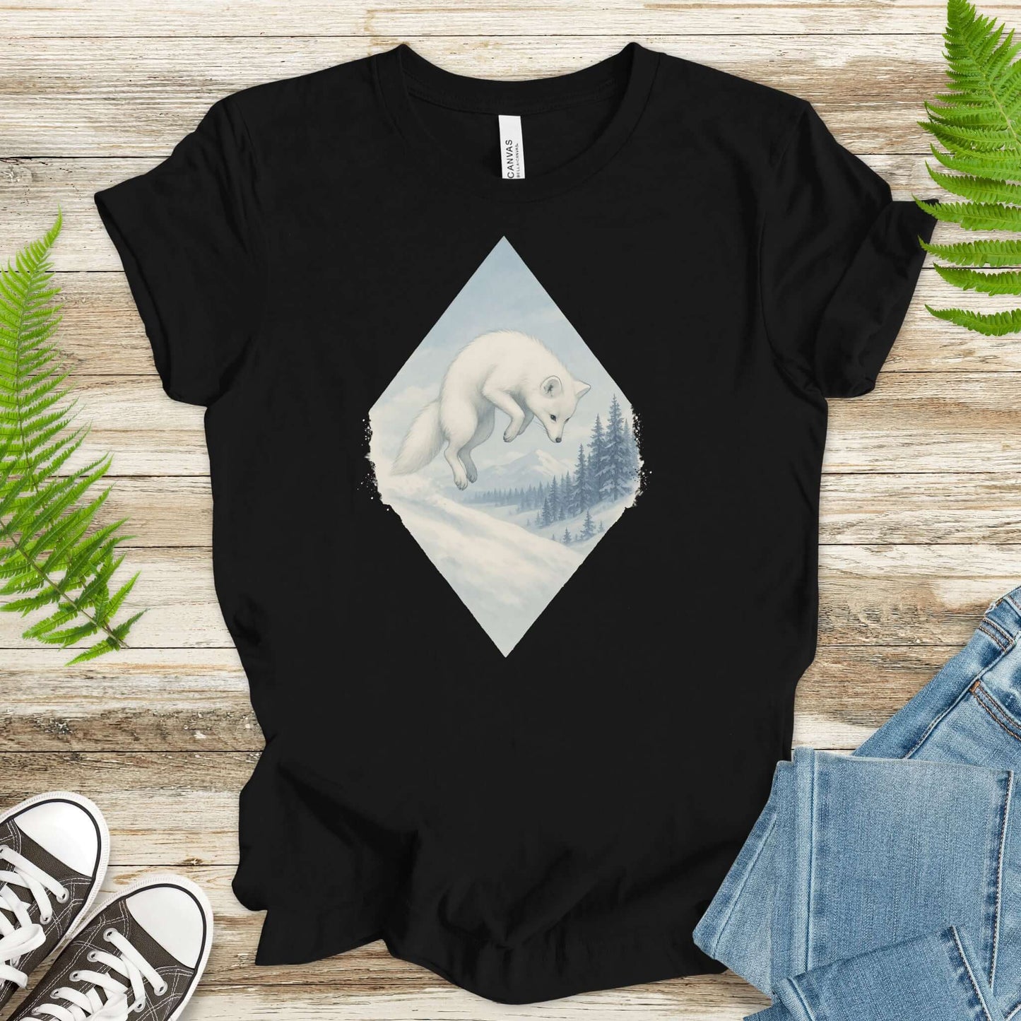 Jumping white fox in snow graphic on black shirt, perfect for fantasy lovers and animal enthusiasts.