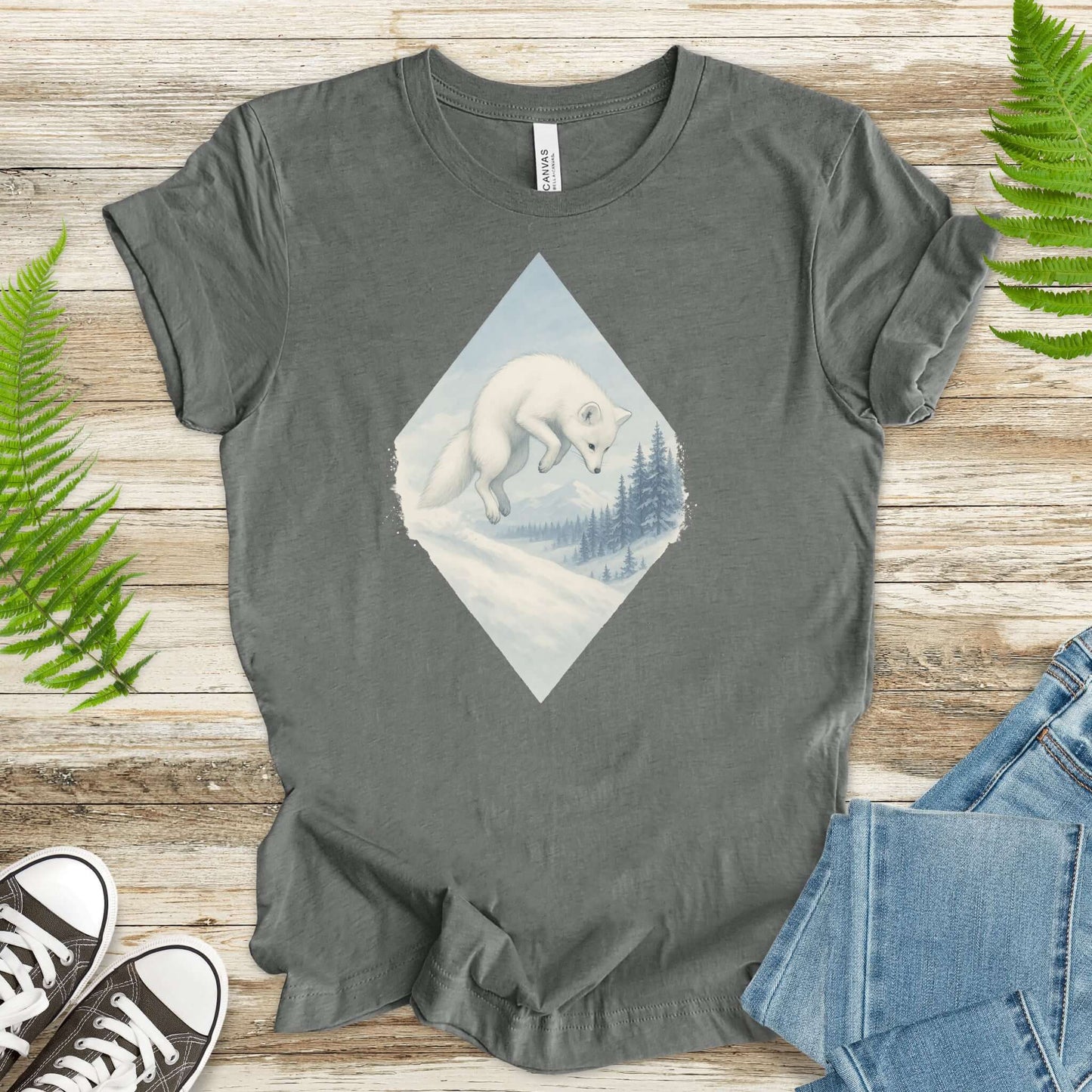Jumping white fox in snow design on gray t-shirt for fantasy lovers and animal enthusiasts.