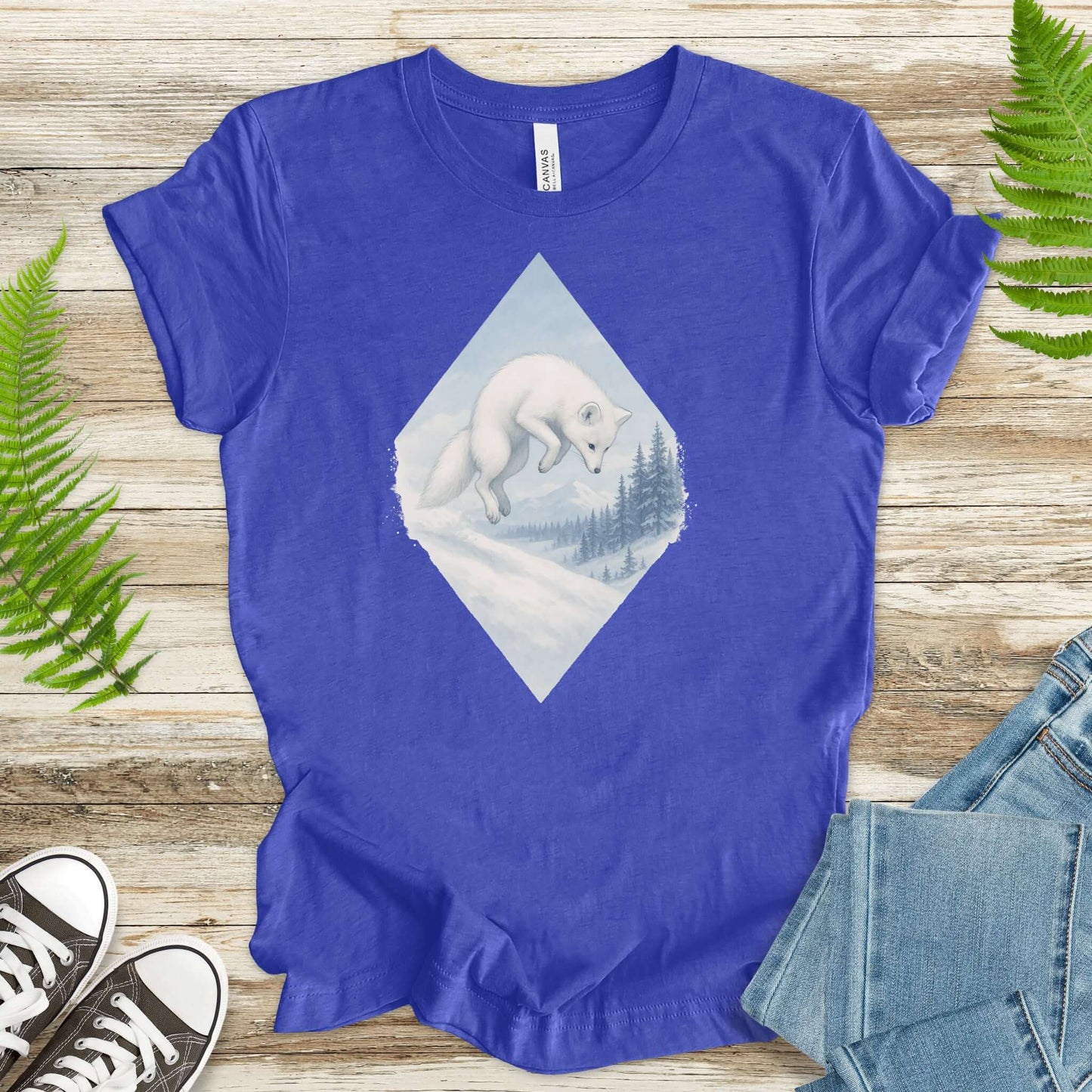 Jumping white fox graphic on a blue fantasy shirt, perfect for nature lovers and animal enthusiasts.