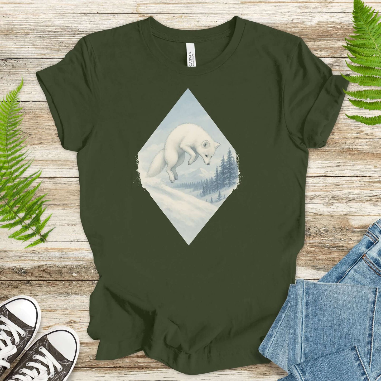 Jumping white fox printed on a green shirt, perfect for fantasy lovers and animal enthusiasts.