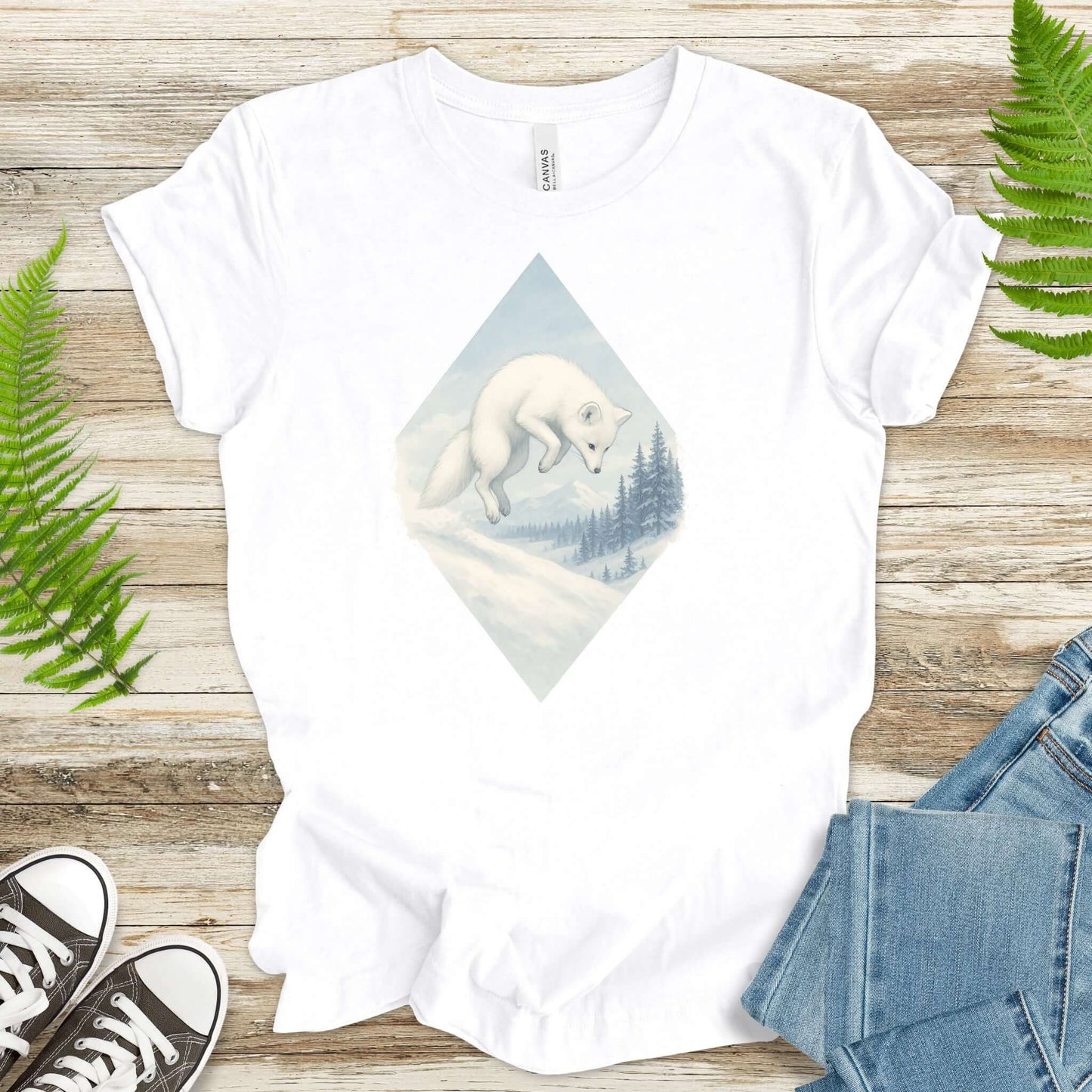 White fox jumping in snow on a shirt, perfect for fantasy lovers and animal enthusiasts.