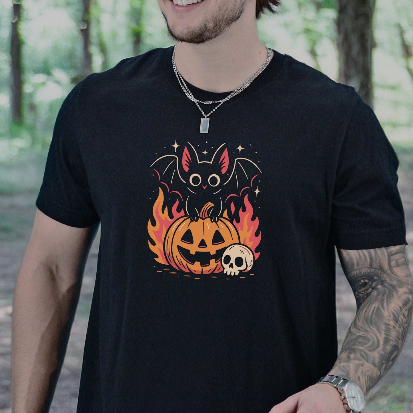 Spooky Bat Halloween T-Shirt featuring a cute bat on a fiery jack-o'-lantern, perfect for goths and pumpkin lovers.