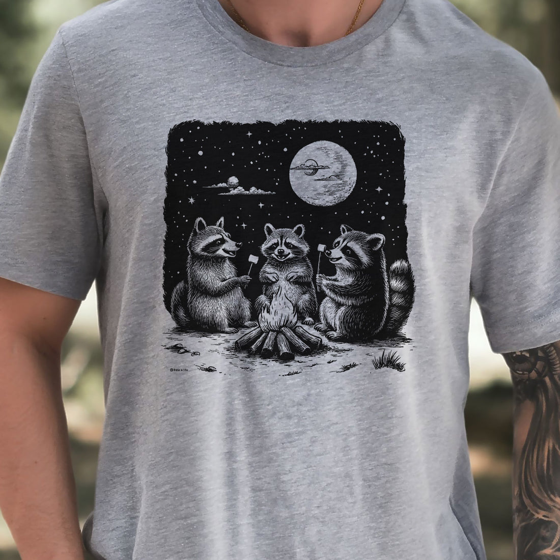 Best Sellers hiking t-shirt featuring raccoons around a campfire under a full moon, perfect for nature lovers.