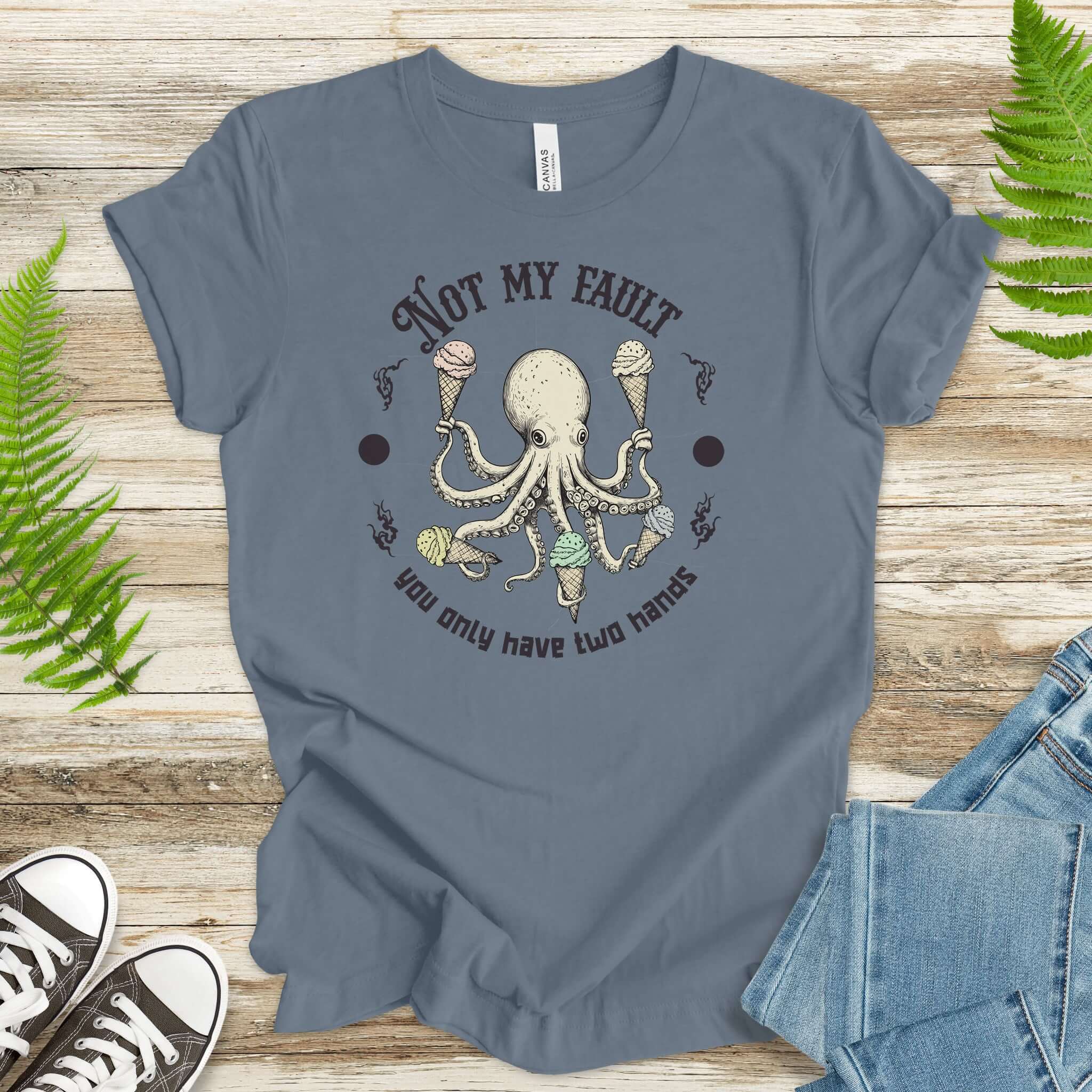 Funny Octopus Ice Cream Lover T-shirt with humorous design and soft fabric on wooden background.