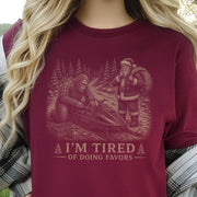 I’m Tired of Doing Favors T-Shirt – Bigfoot Fixing Santa Snowmobile Tee
