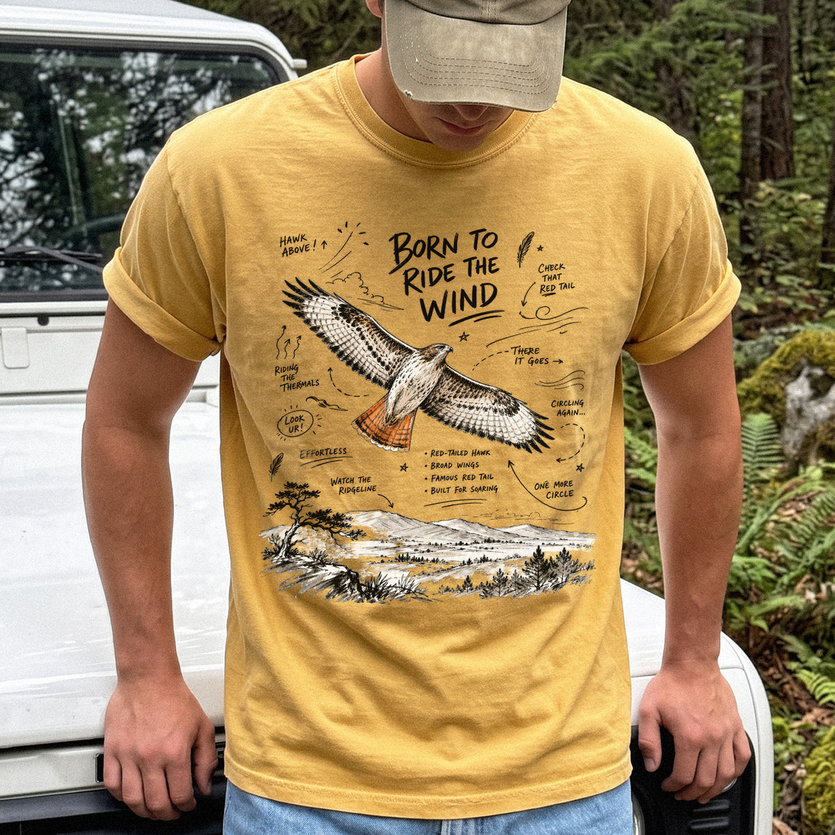 Born to Ride the Wind Comfort Colors Shirt – Red-Tailed Hawk design of a Red-Tailed Hawk illustrated in flight above an open ridgeline, with field-note style callouts and a scenic landscape below, printed on a Mustard T-shirt.