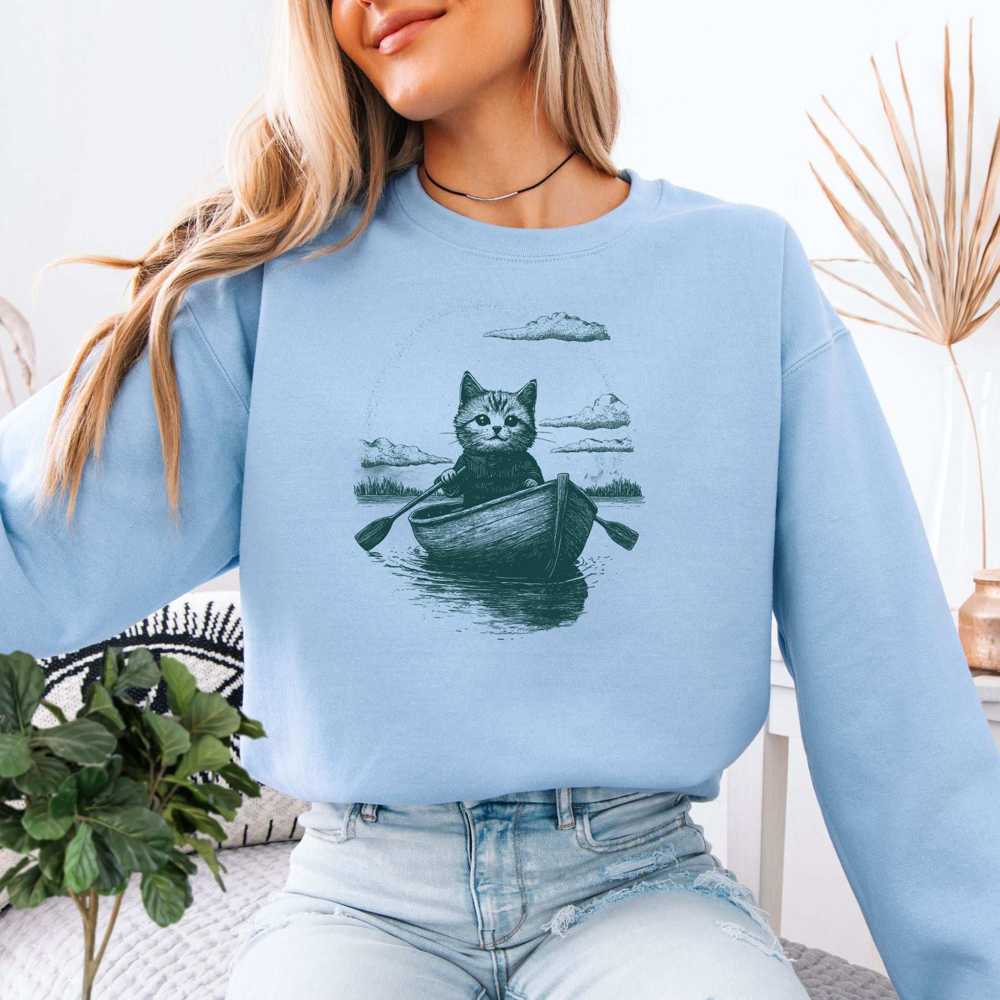 Mysterious Rowboat Cat Sweatshirt – Surreal Moody Art Style