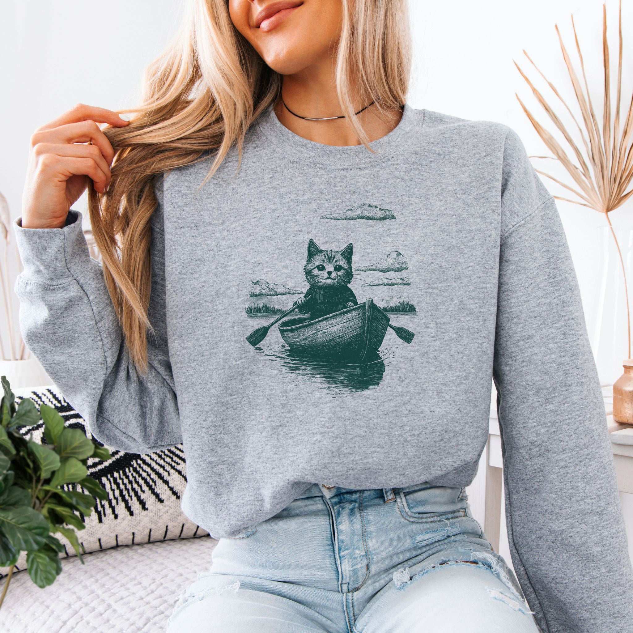 Mysterious Rowboat Cat Sweatshirt – Surreal Moody Art Style