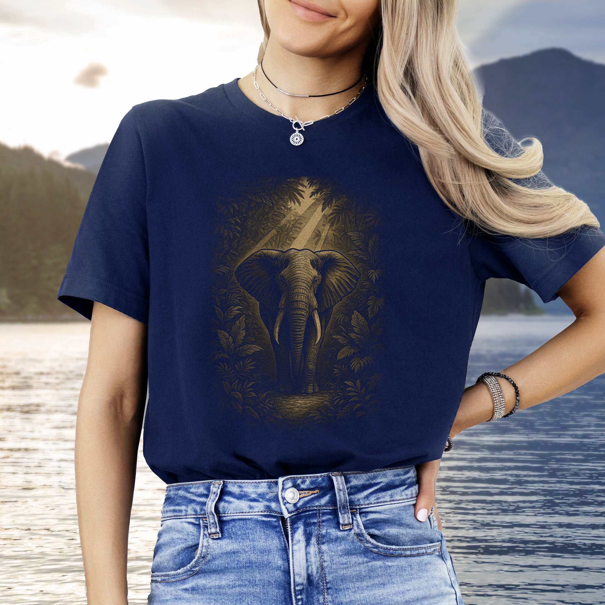 Elephant Spirit Animal T-Shirt – Jungle Majesty & Safari Soul worn by a model near a lake in nature.