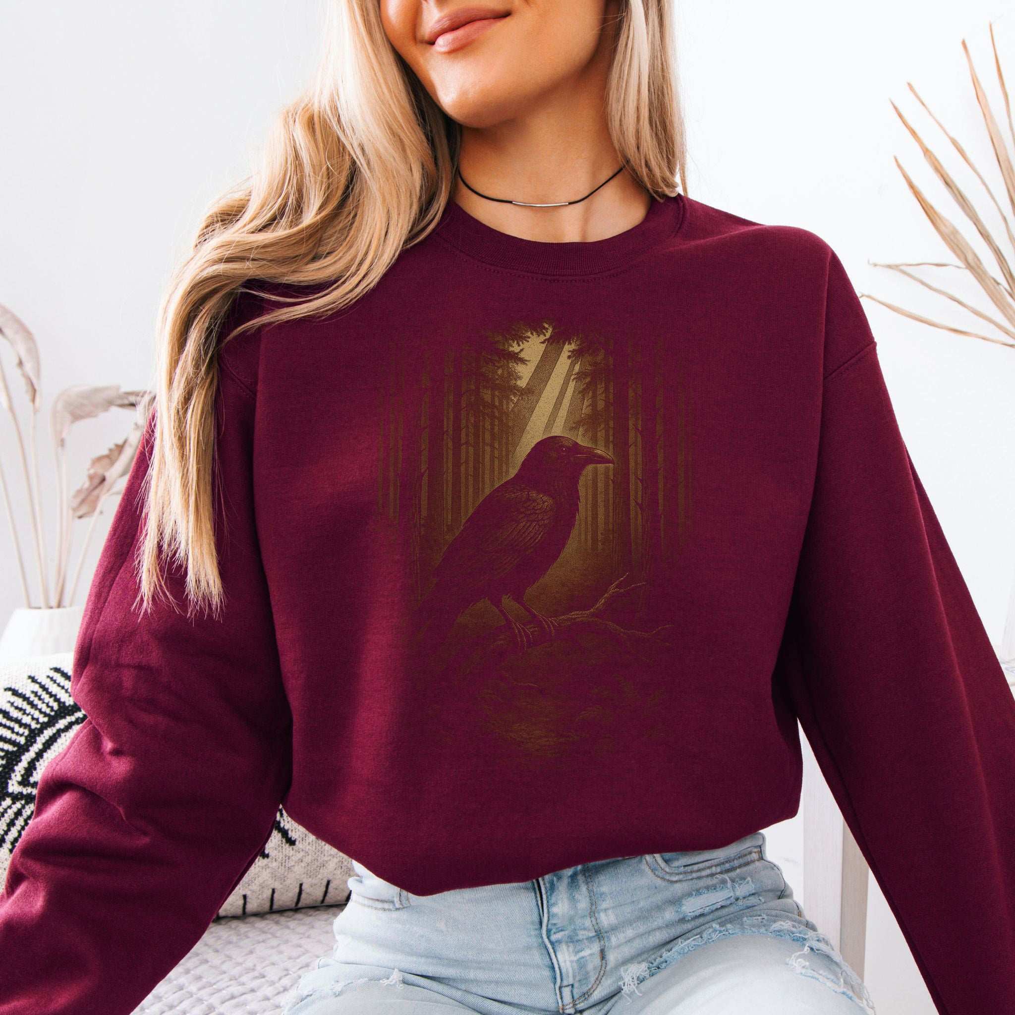 Raven Spirit Animal Sweatshirt – Gothic Forest Mystery Vibes worn by a smiling woman in a cozy setting.