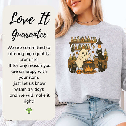 Cozy Ghost & Black Cats Halloween sweatshirt featuring a ghost chef and playful black cats, promoting the Love It Guarantee.