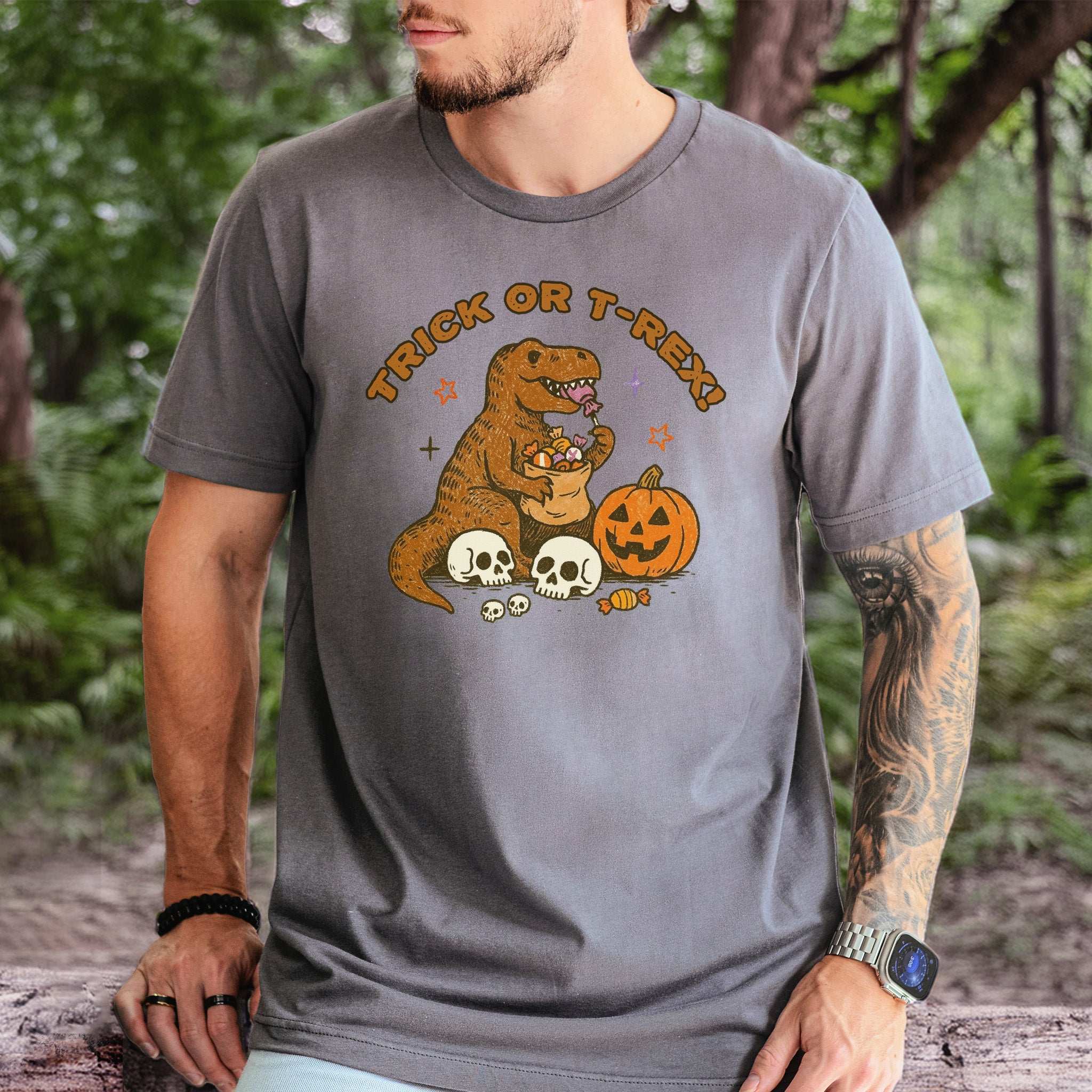 T-Rex Halloween T-Shirt featuring a dino with candy, pumpkins, and skeletons for a fun Trick or Treat vibe.