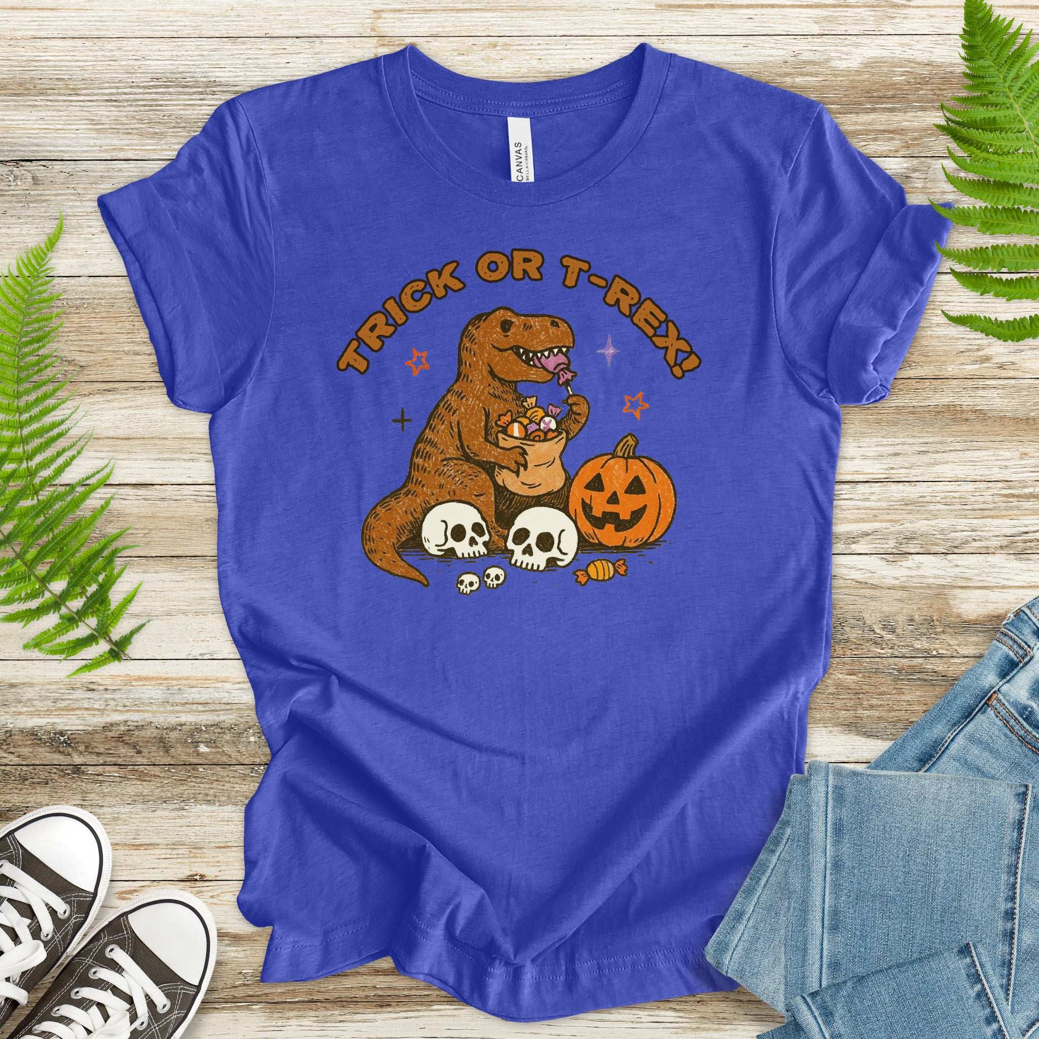 T-Rex Halloween T-Shirt featuring a dino hoarding candy, pumpkins, and skulls - perfect for Trick or Treat fun!