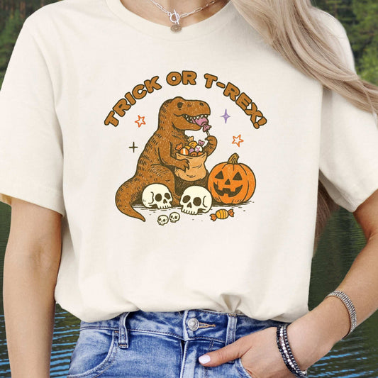 T-Rex Halloween T-Shirt featuring a dinosaur with candy and pumpkin, perfect for Trick or Treat vibes.