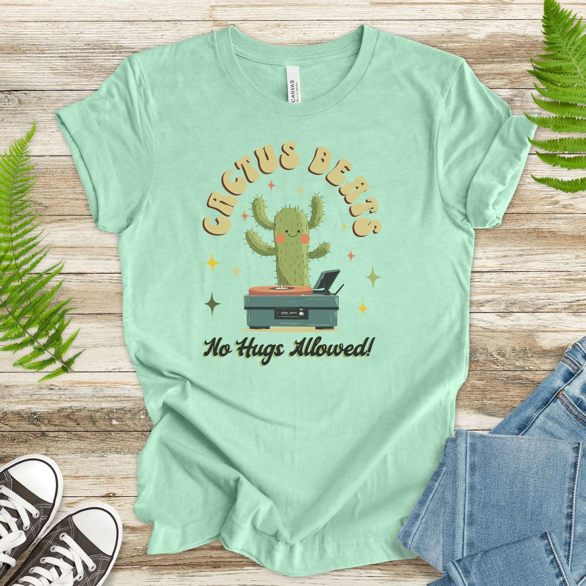 Funny Retro DJ Cactus T-Shirt in soft cotton, featuring a cactus DJ and the phrase 'No Hugs Allowed', perfect for music lovers.