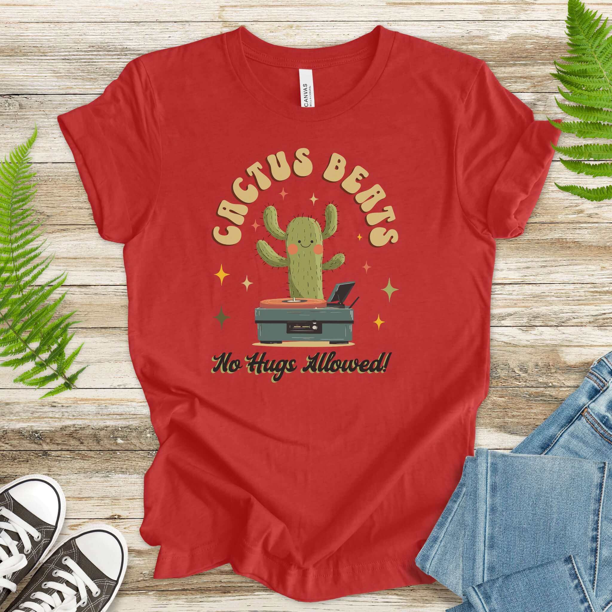 Funny retro cactus DJ T-shirt in cotton with graphic that says 'Cactus Beats No Hugs Allowed' on a vibrant red background.