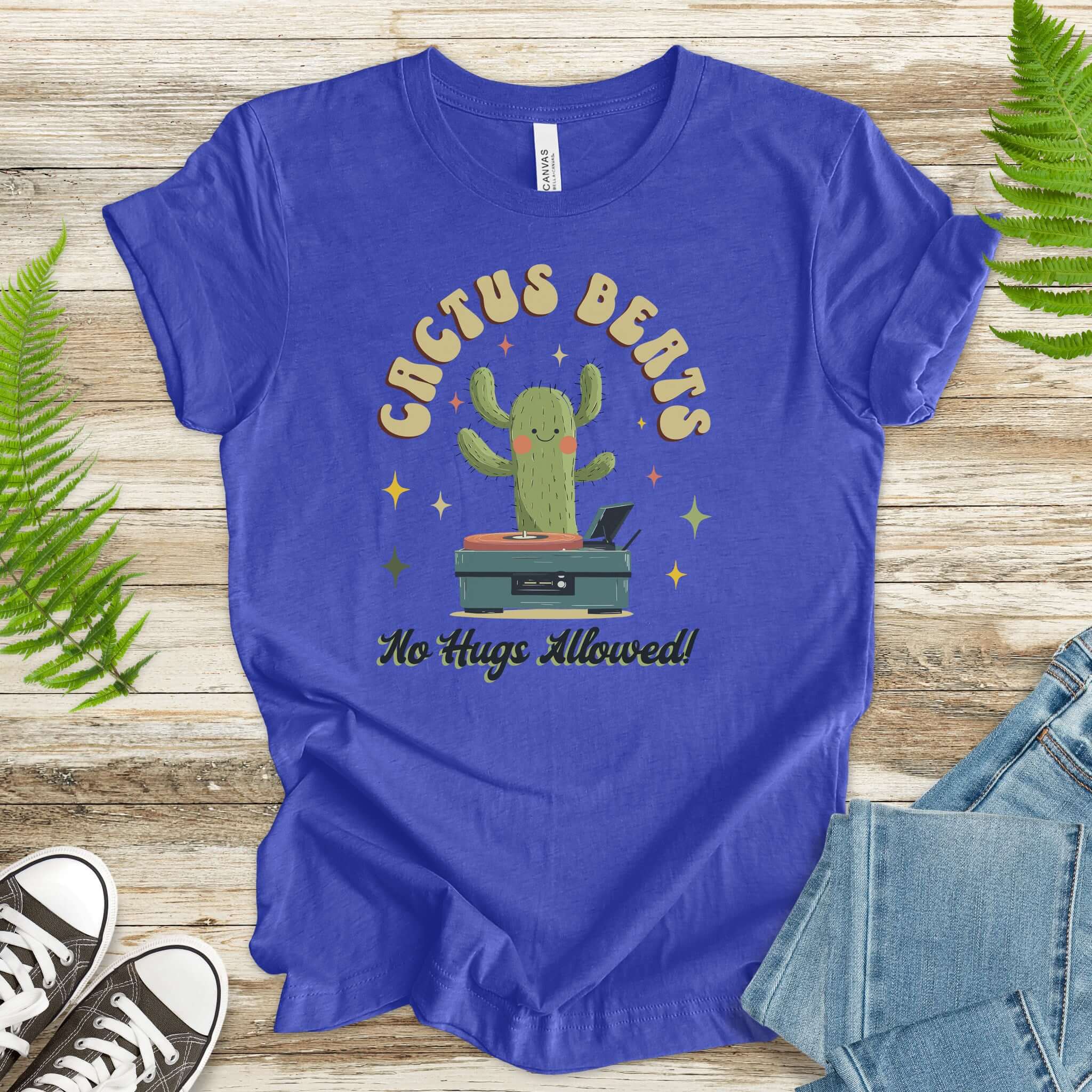 Funny retro DJ cactus T-shirt in blue, features a cartoon cactus DJ with the text 'Cactus Beats - No Hugs Allowed!'. Cotton, soft graphic tee.