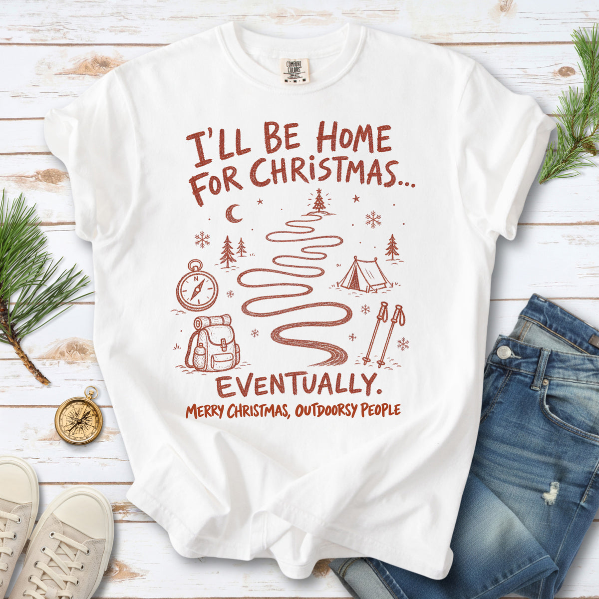 A winding trail with a tent, compass, backpack, trekking poles, snowflakes, and pine trees, doodle style design on a White T-shirt