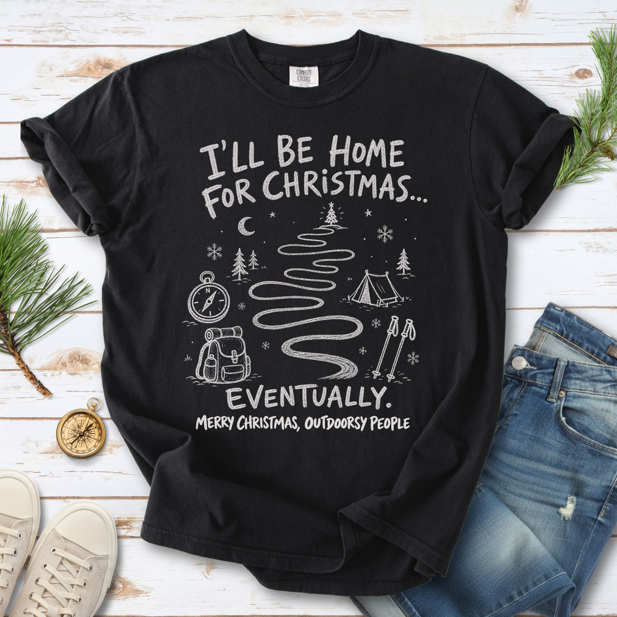 A winding trail with a tent, compass, backpack, trekking poles, snowflakes, and pine trees, doodle style design on a Black T-shirt