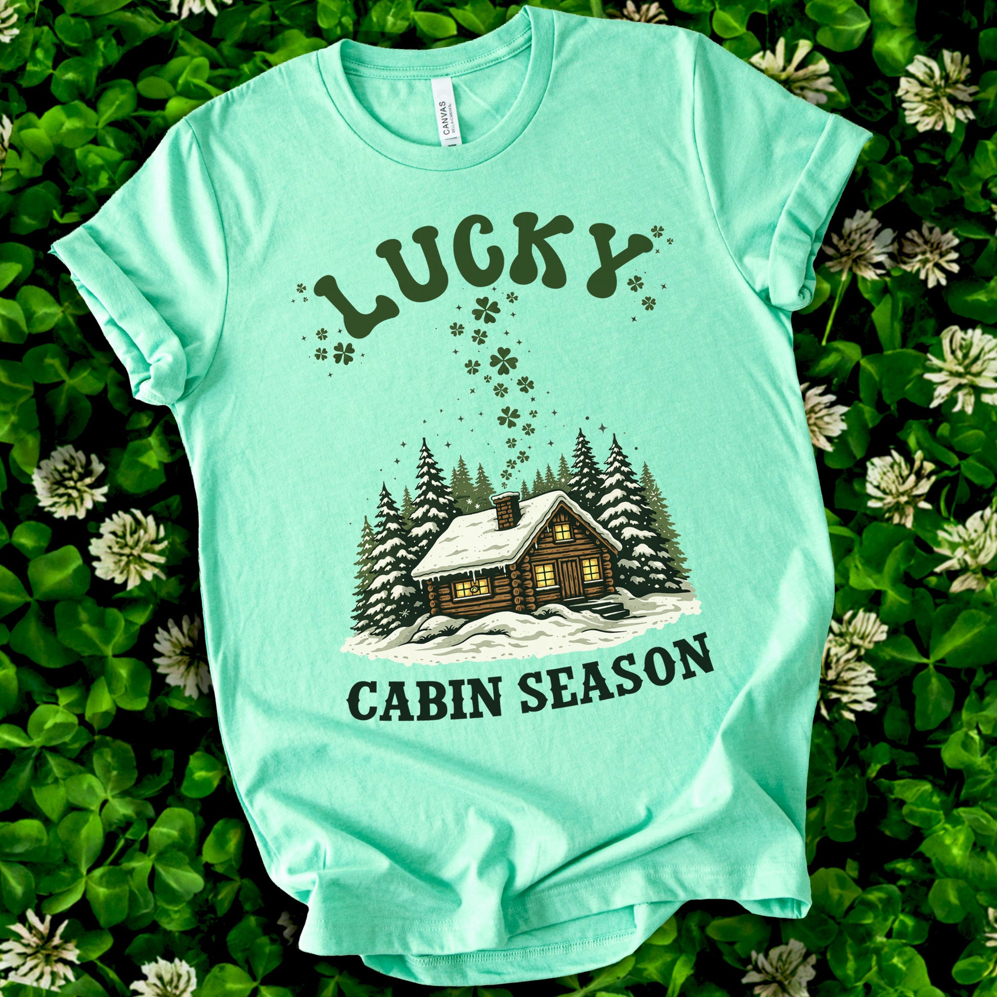 Lucky Cabin Season T-Shirt – Cozy Snowy Forest Tee for St. Patrick’s Day