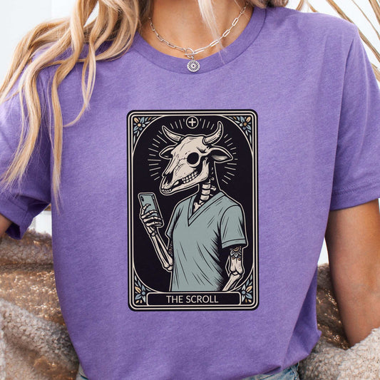 Bull skull tarot card design on a purple T-shirt, featuring a skeleton using a phone to represent tech addiction.