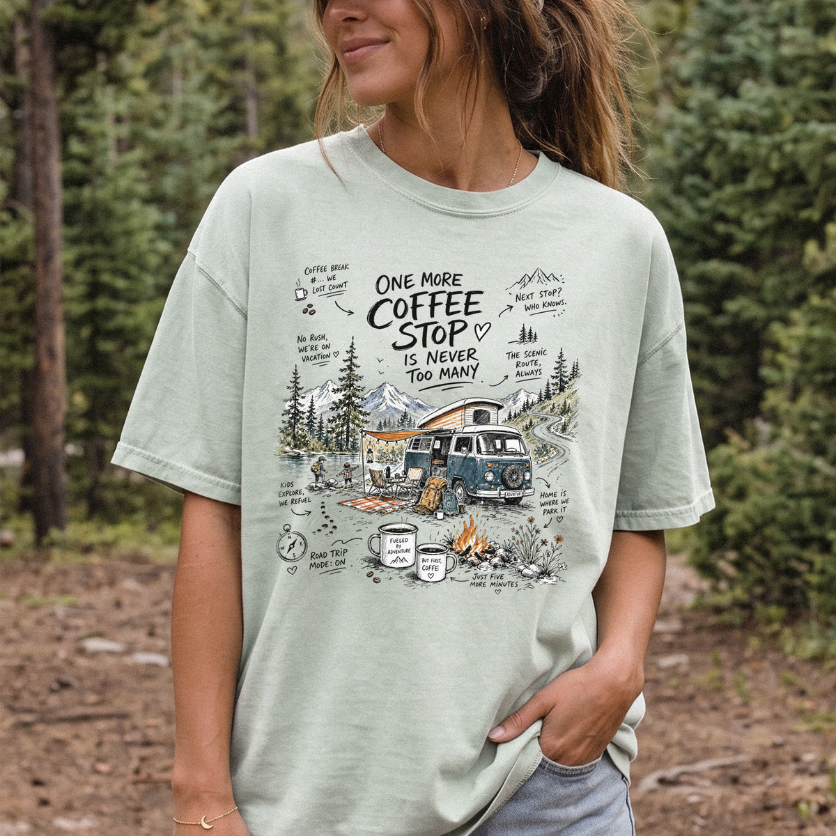 Woman wearing a Bay Comfort Colors T-shirt printed with a retro camper van parked by the water with mountain views and camp chairs