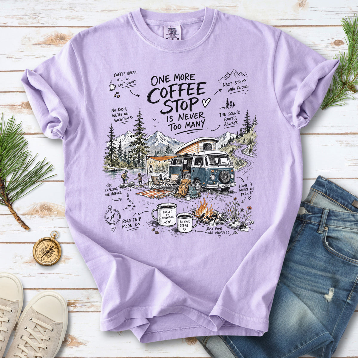 A retro camper van parked by the water with mountain views and camp chairs design on an Orchid Comfort Colors T-shirt