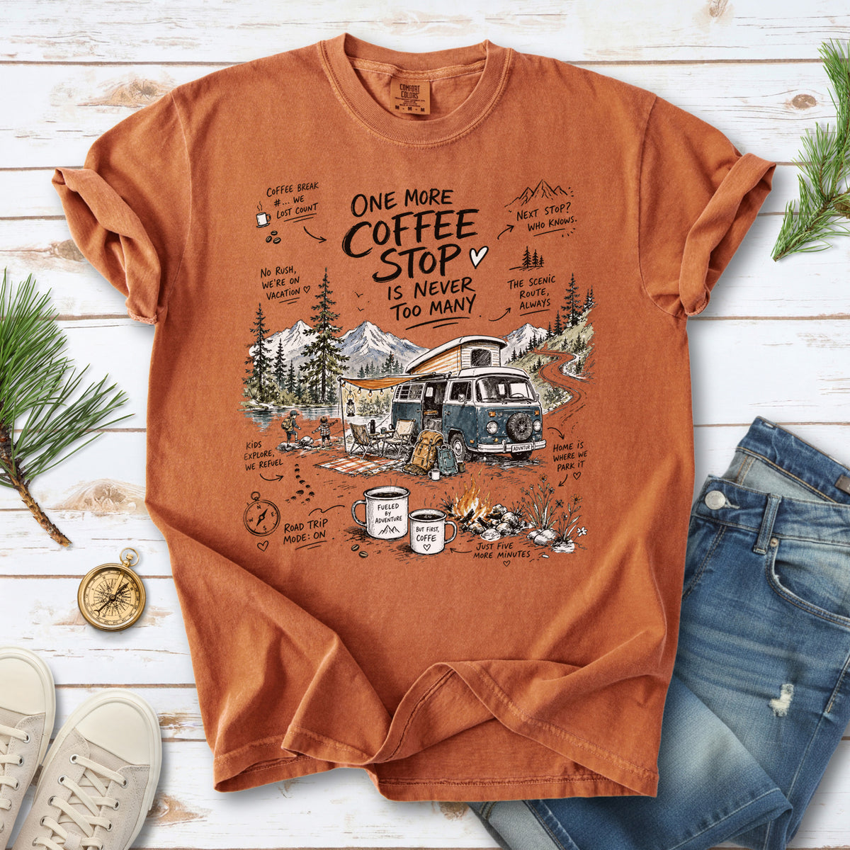 A retro camper van parked by the water with mountain views and camp chairs design on a Yam Comfort Colors T-shirt
