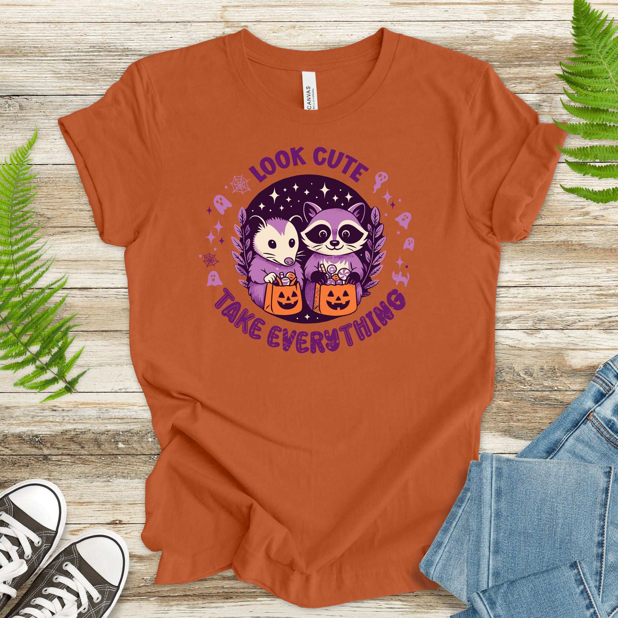 Opossum & Raccoon Halloween T-shirt with 'Look Cute, Take Everything' print, perfect for festive fun.