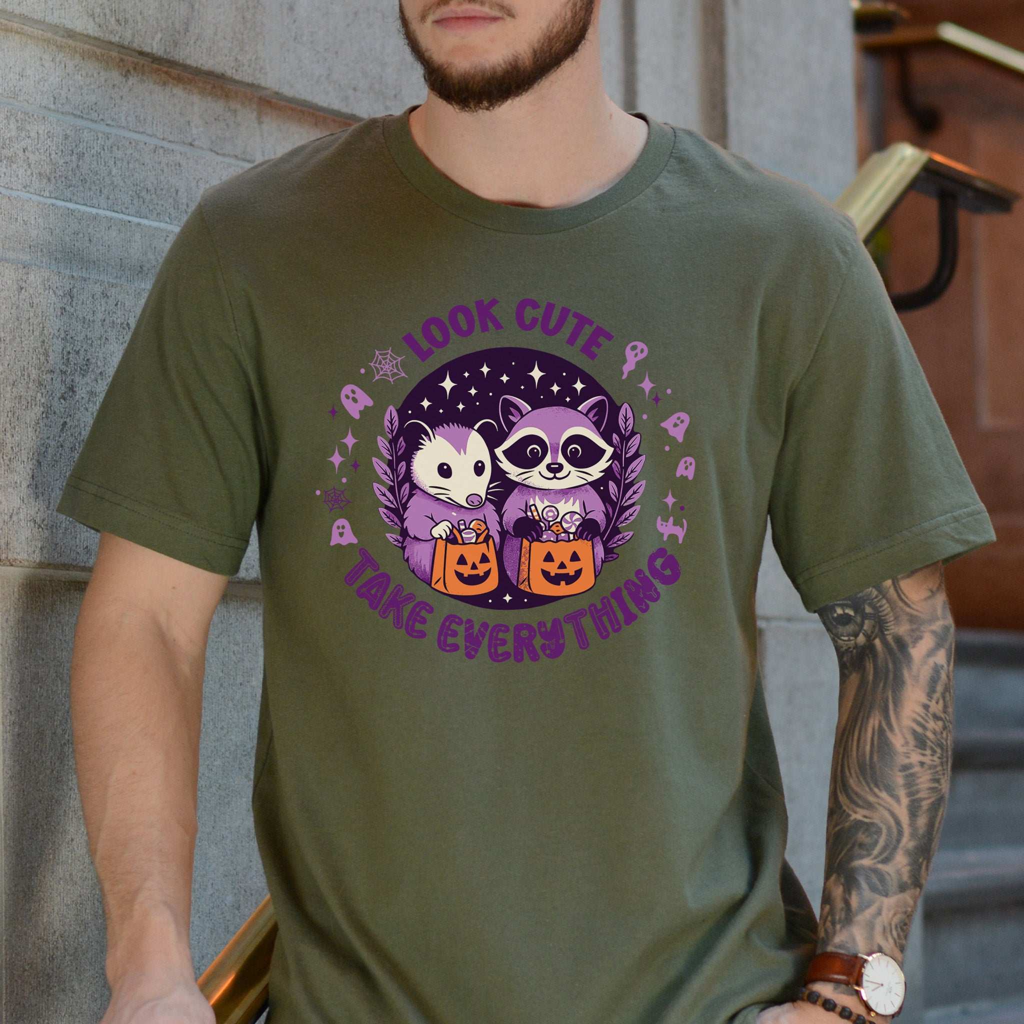 Opossum & Raccoon Halloween T-shirt featuring cute design and playful text, perfect for Halloween fun.
