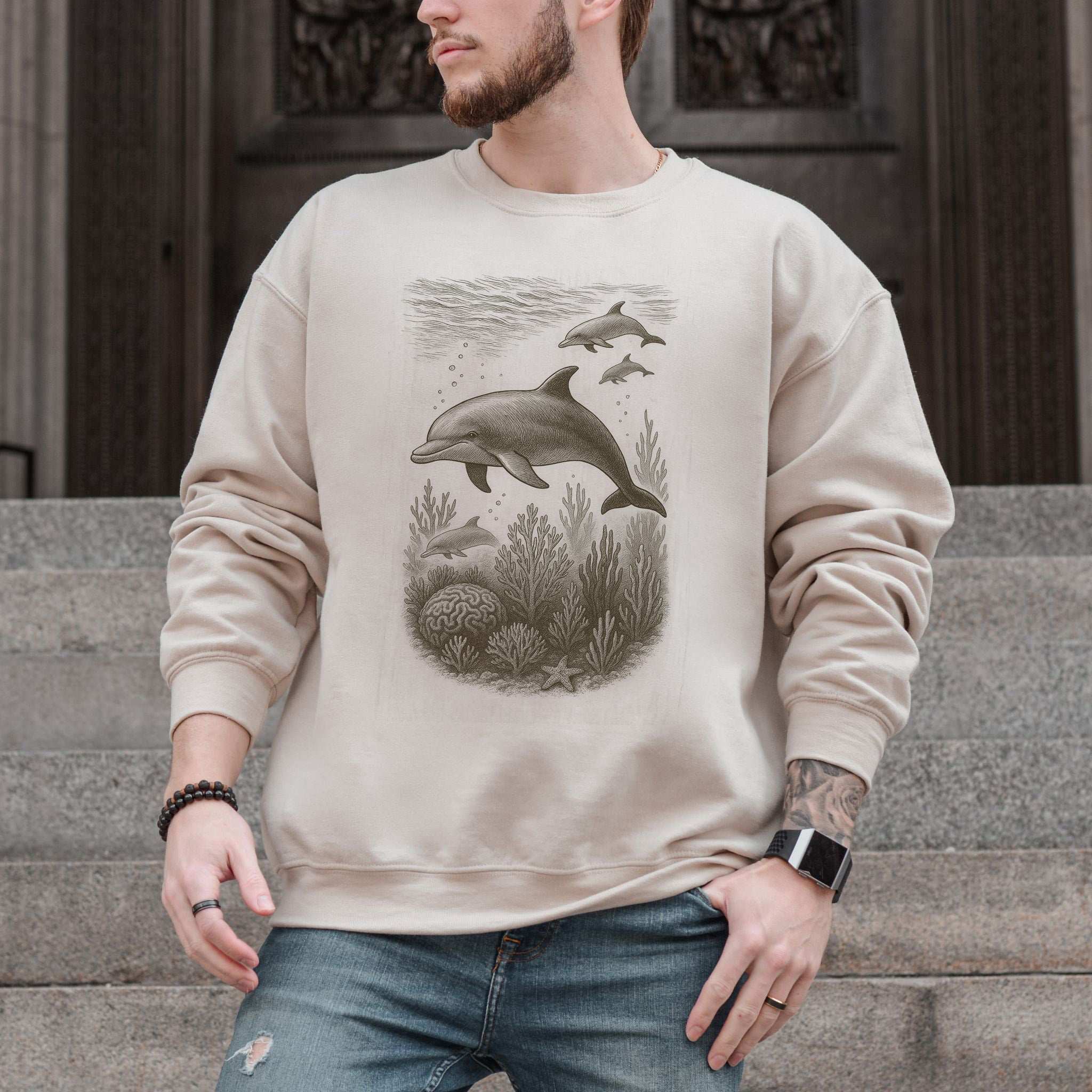 Dolphins and coral reef sketch on a cozy ocean spirit animal sweatshirt worn by a man.