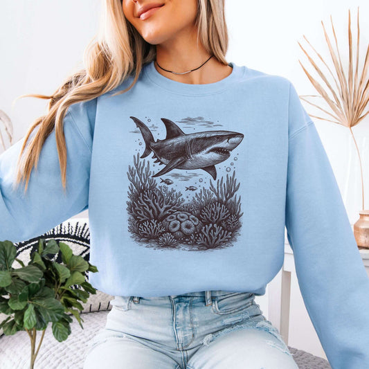 Shark and Coral Reef Sweatshirt featuring a hand-drawn shark swimming through a coral reef design.