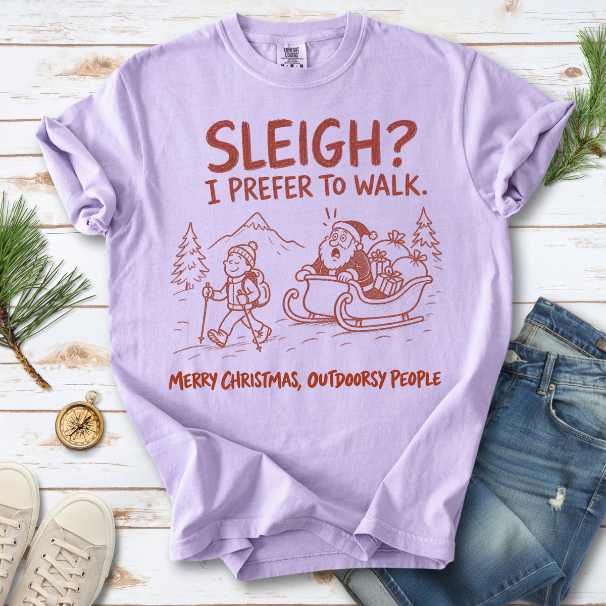 A hiker with trekking poles and a surprised Santa in his sleigh against a mountain backdrop, doodle line-art style design on an Orchid T-shirt