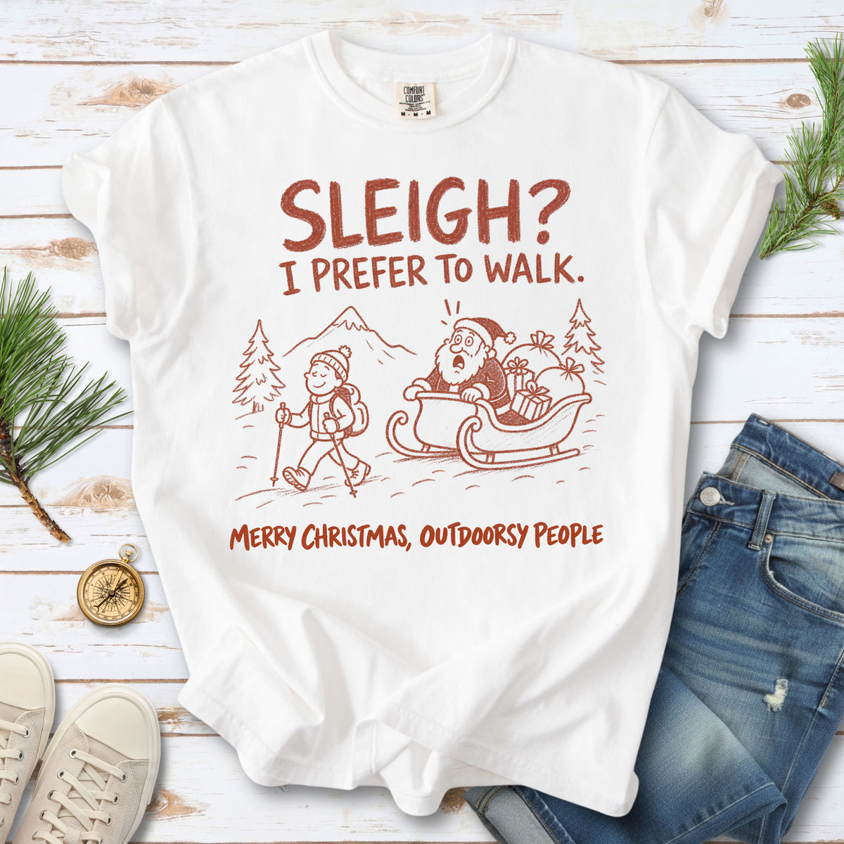 A hiker with trekking poles and a surprised Santa in his sleigh against a mountain backdrop, doodle line-art style design on a White T-shirt