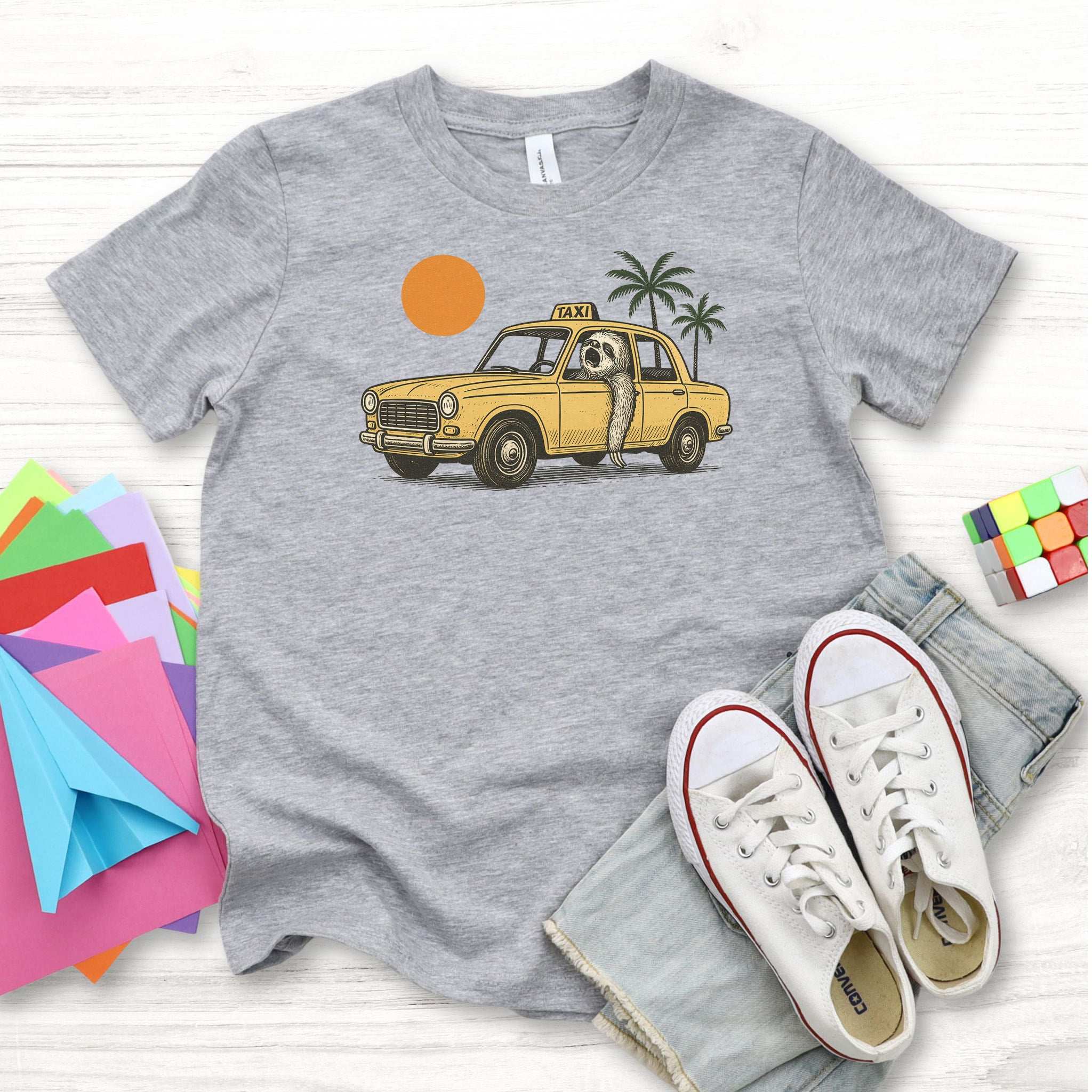 Sloth Taxi Driver – Tropical Sunset Cruiser Youth Tee