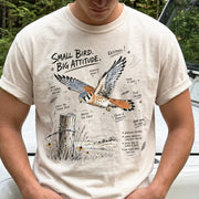 Small Bird, Big Attitude Comfort Colors Shirt – American Kestrel design of an American Kestrel illustrated in mid-flight above an open field, with fence-post details and field-note style callouts, printed on an Ivory T-shirt.